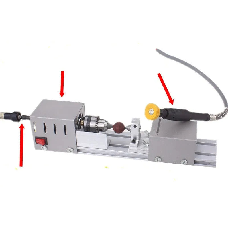 Silver metal mini woodworking lathe with carving knives and tools on workbench