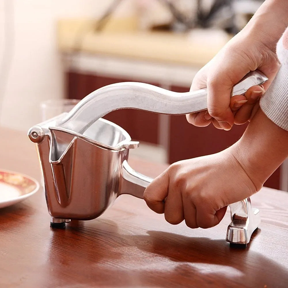 Silver heavy duty lemon squeezer with large bowl on a kitchen counter