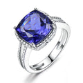 Women's sterling silver ring with a blue tanzanite gemstone on a silver band.