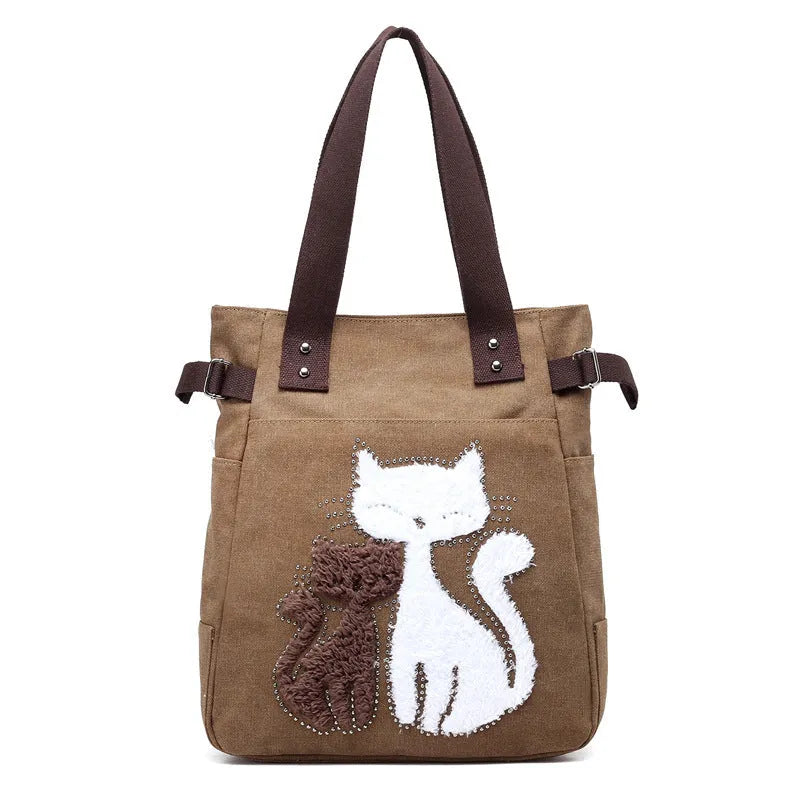 KVKY women canvas bag with plush cat applique in beige, showing shoulder strap and front pocket