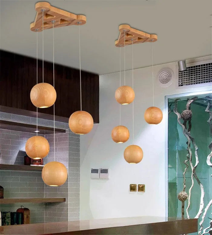 Nordic style wooden ball chandelier with solid wood construction hanging from a ceiling on an adjustable cord.