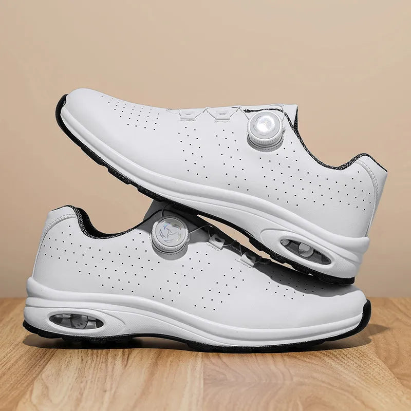 Black and white low top casual tennis shoes with cross shoulder straps and mesh upper.