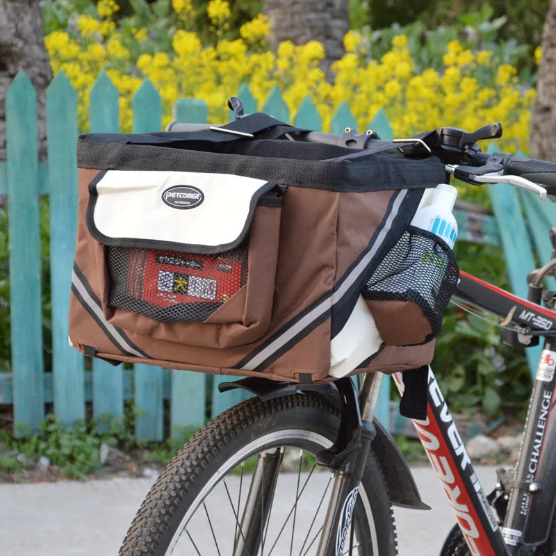 Pet bicycle carrier in Oxford material for small cats and dogs, attached to handlebars with traction hook visible