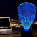 Compact USB-powered 3D LED desk lamp with a touch switch and remote control on a desk.