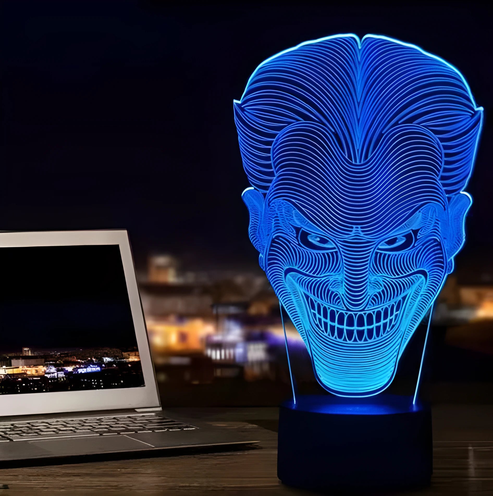 Compact USB-powered 3D LED desk lamp with a touch switch and remote control on a desk.