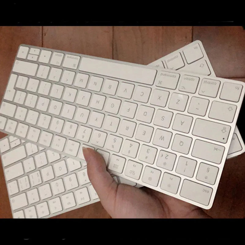 White Apple G6 Bluetooth wireless keyboard with ultra-thin metal design on desk