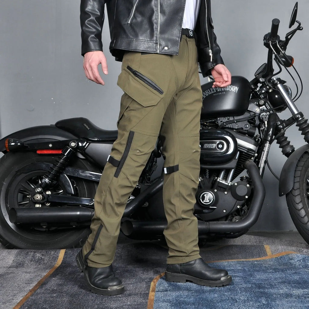 Men's green waterproof motorcycle trousers with belt and protective knee pads laid flat.