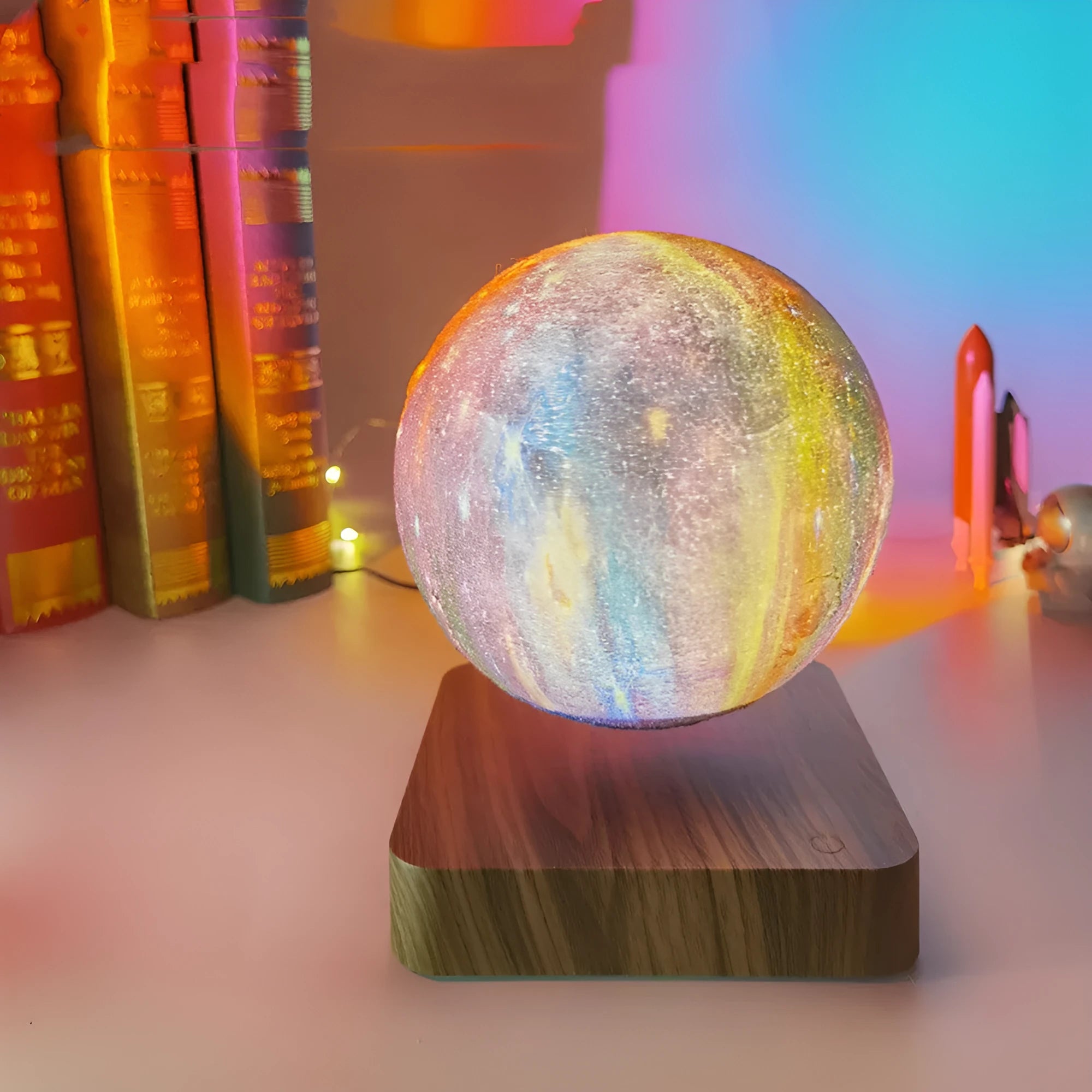 Square walnut coloured levitating moon lamp with galaxy light effect rotating above a circular base.