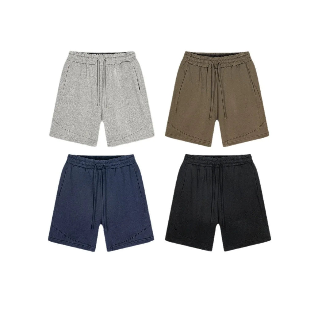 Child wearing solid colour loose cotton sports shorts in a neutral shade.