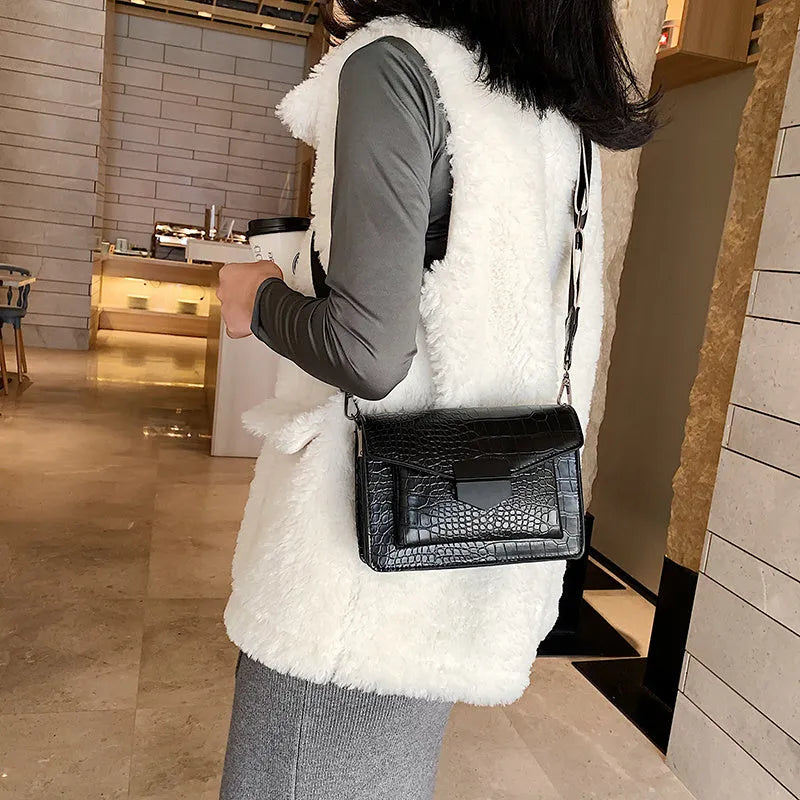 A PU fabric crossbody bag with an adjustable strap, shown in dark brown colour.