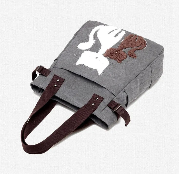 KVKY women canvas bag with plush cat applique in beige, showing shoulder strap and front pocket