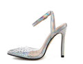 Women's pointed toe stiletto sandals with a diamond embellishment on the PVC upper and an adjustable ankle strap.
