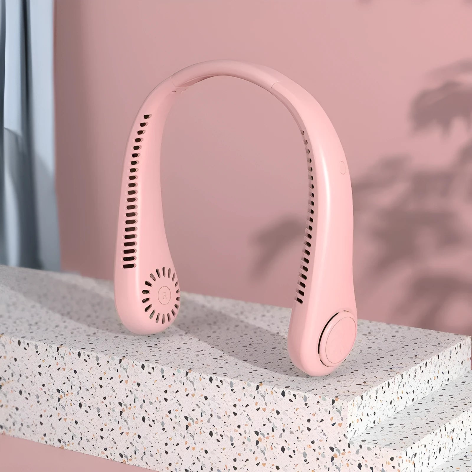 Pink USB rechargeable portable bladeless neck fan being worn.
