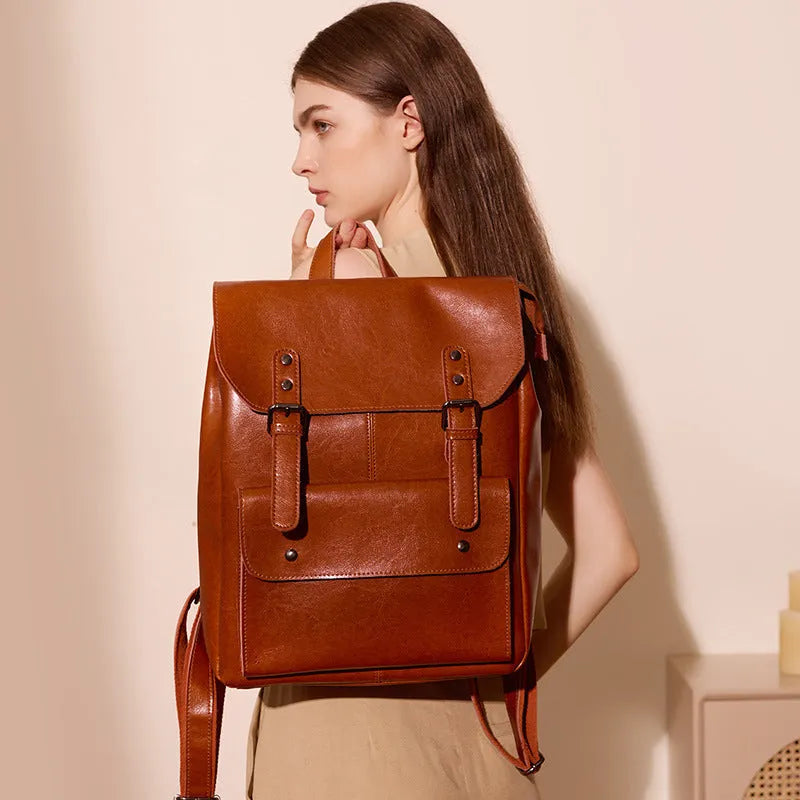 Black two-layer cowhide leather computer backpack for women with internal lining.