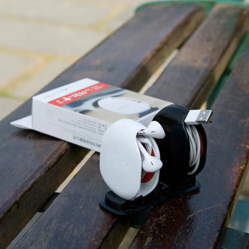 Automatic earphone cable winder showing white, blue, and black units with cable retracted into 72mm storage box.