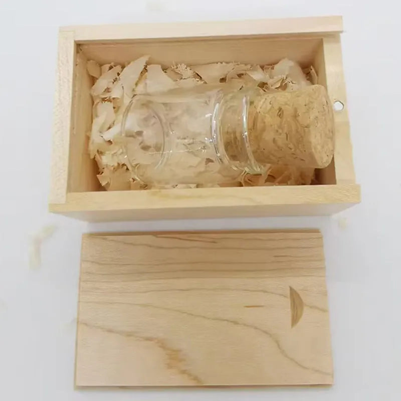 Transparent bottle-shaped USB flash drive with a wooden charm inside, showing metal connector.