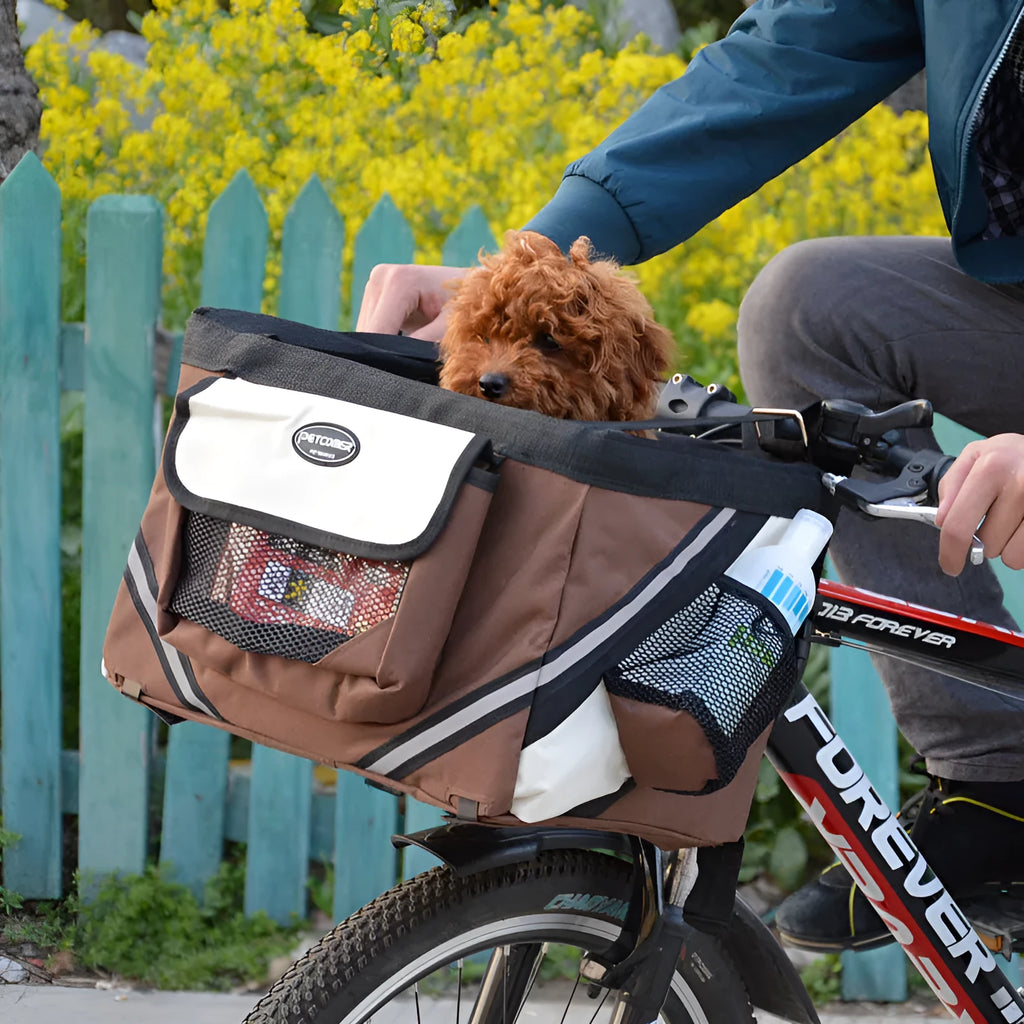 Pet bicycle carrier in Oxford material for small cats and dogs, attached to handlebars with traction hook visible