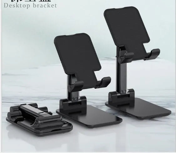 Black adjustable desk mobile phone holder with silicone base on a wooden desk.