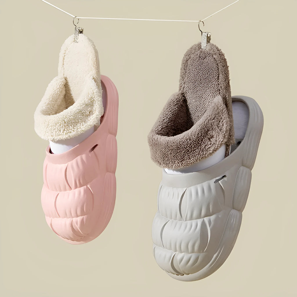 Removable fluffy slippers in beige with faux fur lining and Velcro fastening on a wooden floor