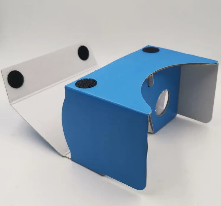 Pink and white cardboard VR glasses with adjustable rubber head strap and 3D lenses for smartphones.