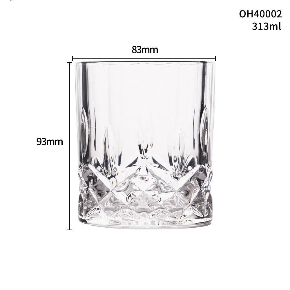 Clear crystal whiskey shot glass with thick bottom base on a table.