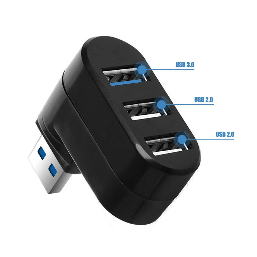 Black USB rotary splitter hub with four ports on a rotating white ABS body, shown on a desk.