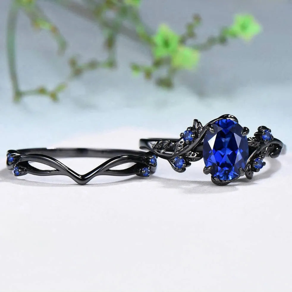 Gun black geometric copper women's ring with an inlaid navy blue rhinestone, shown in size 10.