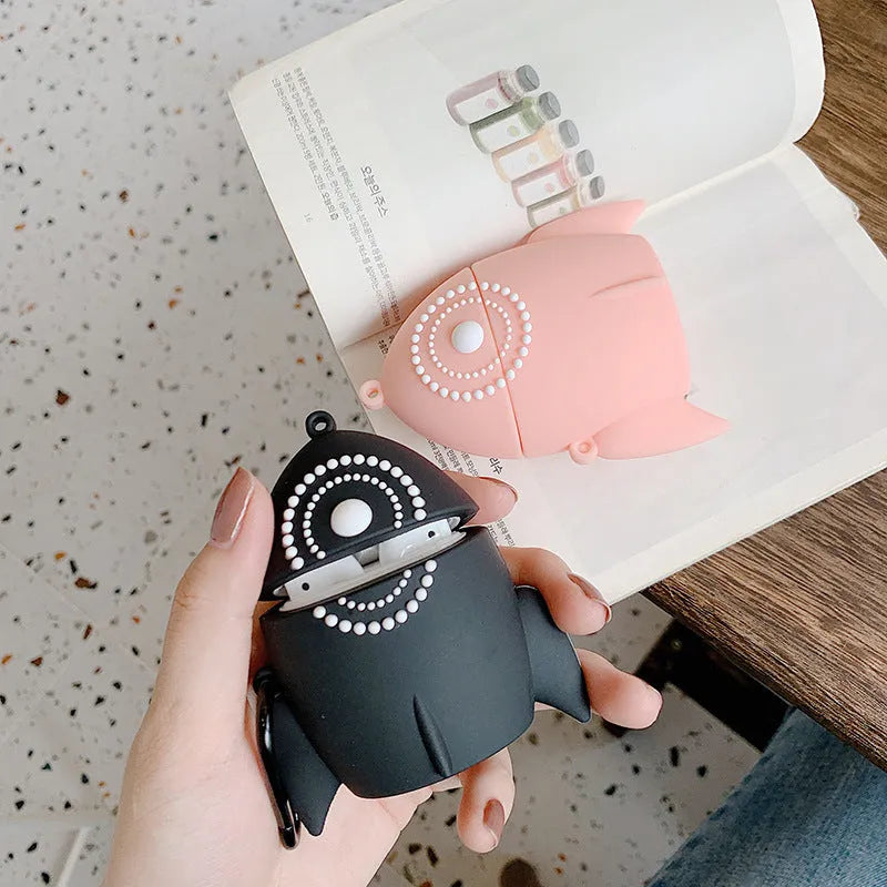 Pink silicone AirPods case with raised rocket design next to black plain version