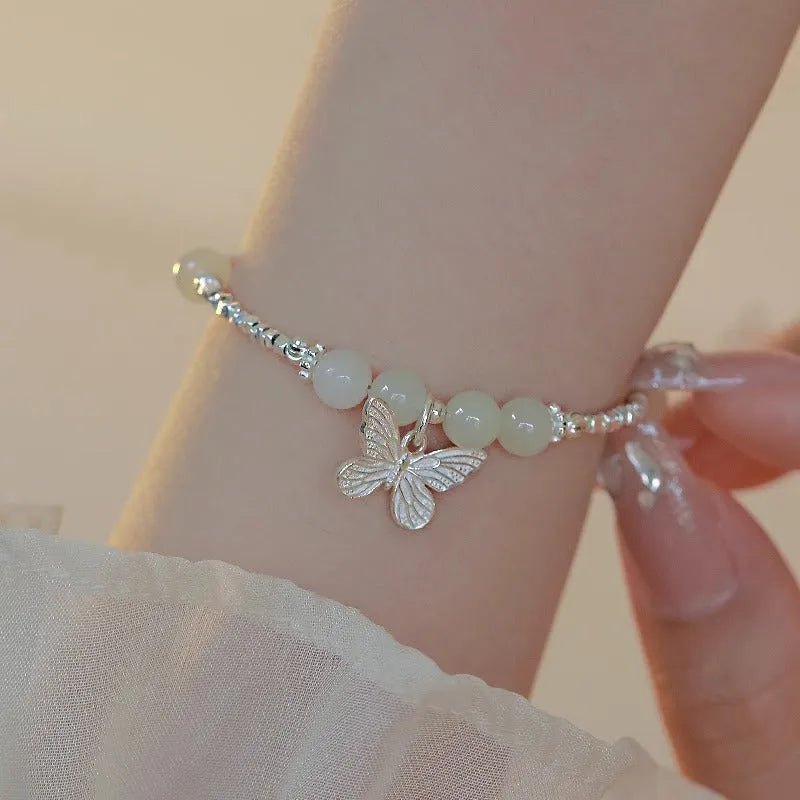 Copper bracelet and necklace set with silver electroplating and butterfly designs featuring Hetian jade accents