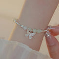 Copper bracelet and necklace set with silver electroplating and butterfly designs featuring Hetian jade accents
