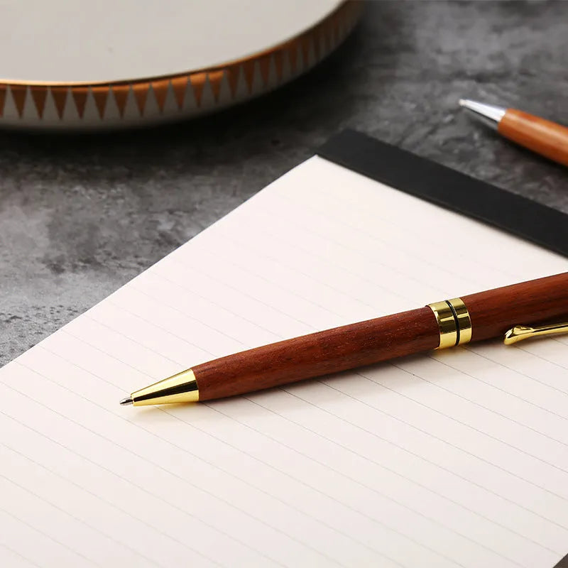 Rosewood and metal ballpoint pen 14cm long with gold and silver finish options on a white background
