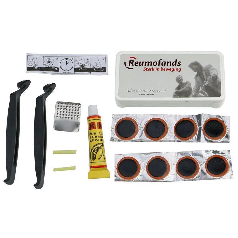 Black bicycle saddle with silicone padding and two visible steel springs underneath, shown with a waterproof cover and tools.