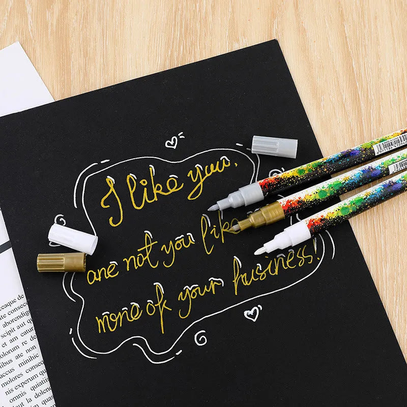 Set of six colourful acrylic marker pens with 0.7mm nibs in a plastic storage box.