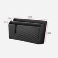 Black PVC carbon fibre pattern phone storage box with reusable adhesive on a car seat surface