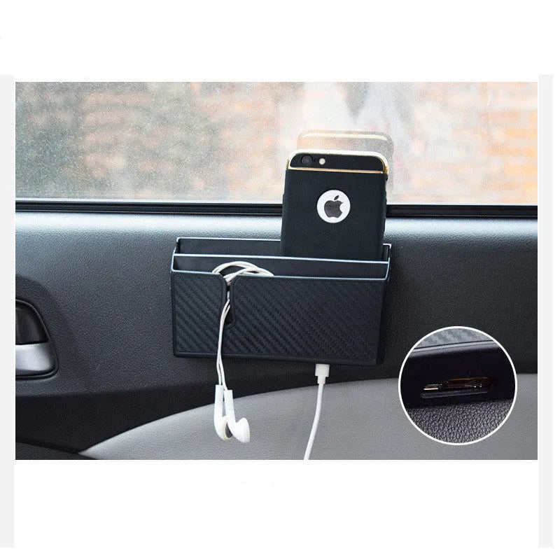 Black PVC carbon fibre pattern phone storage box with reusable adhesive on a car seat surface
