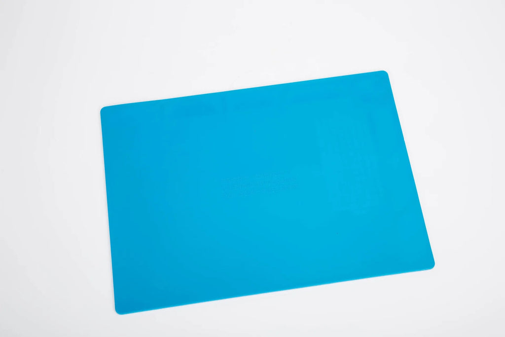 Blue silicone watch repair mat with non-slip surface for component organisation during watch work