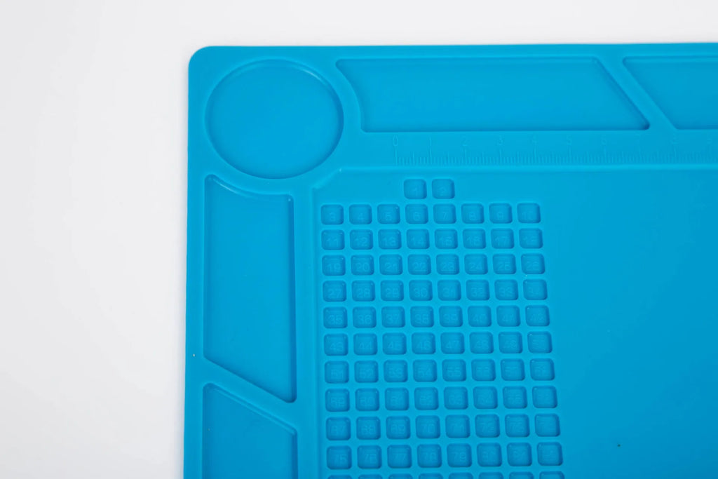 Blue silicone watch repair mat with non-slip surface for component organisation during watch work