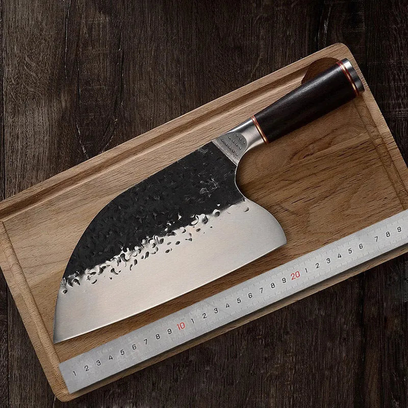Stainless steel kitchen knife with ebony wood handle for cutting meat and bones.