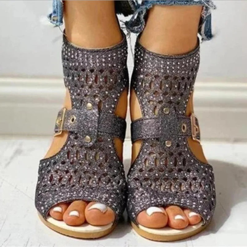Beige women's flat sandals with a back zipper, fish mouth toe, and low wedge heel on a white background.