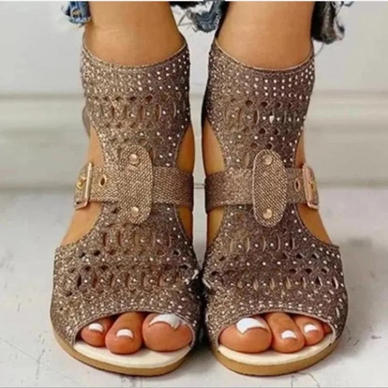 Beige women's flat sandals with a back zipper, fish mouth toe, and low wedge heel on a white background.