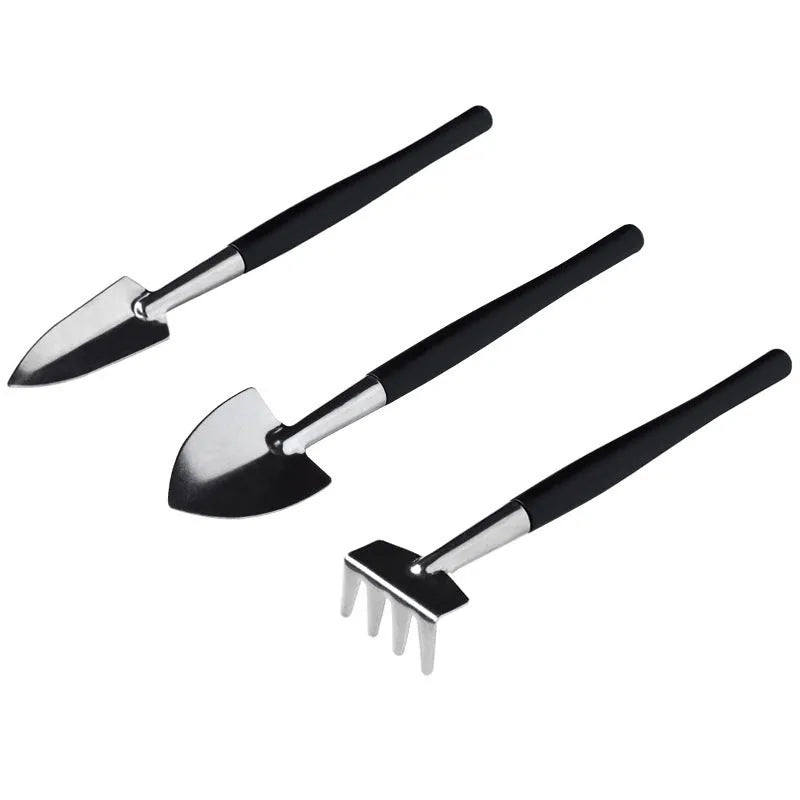 Black plastic and metal mini garden tool set with 16 pieces including small shovel, tweezers, scissors, and a grey kneeling cushion.