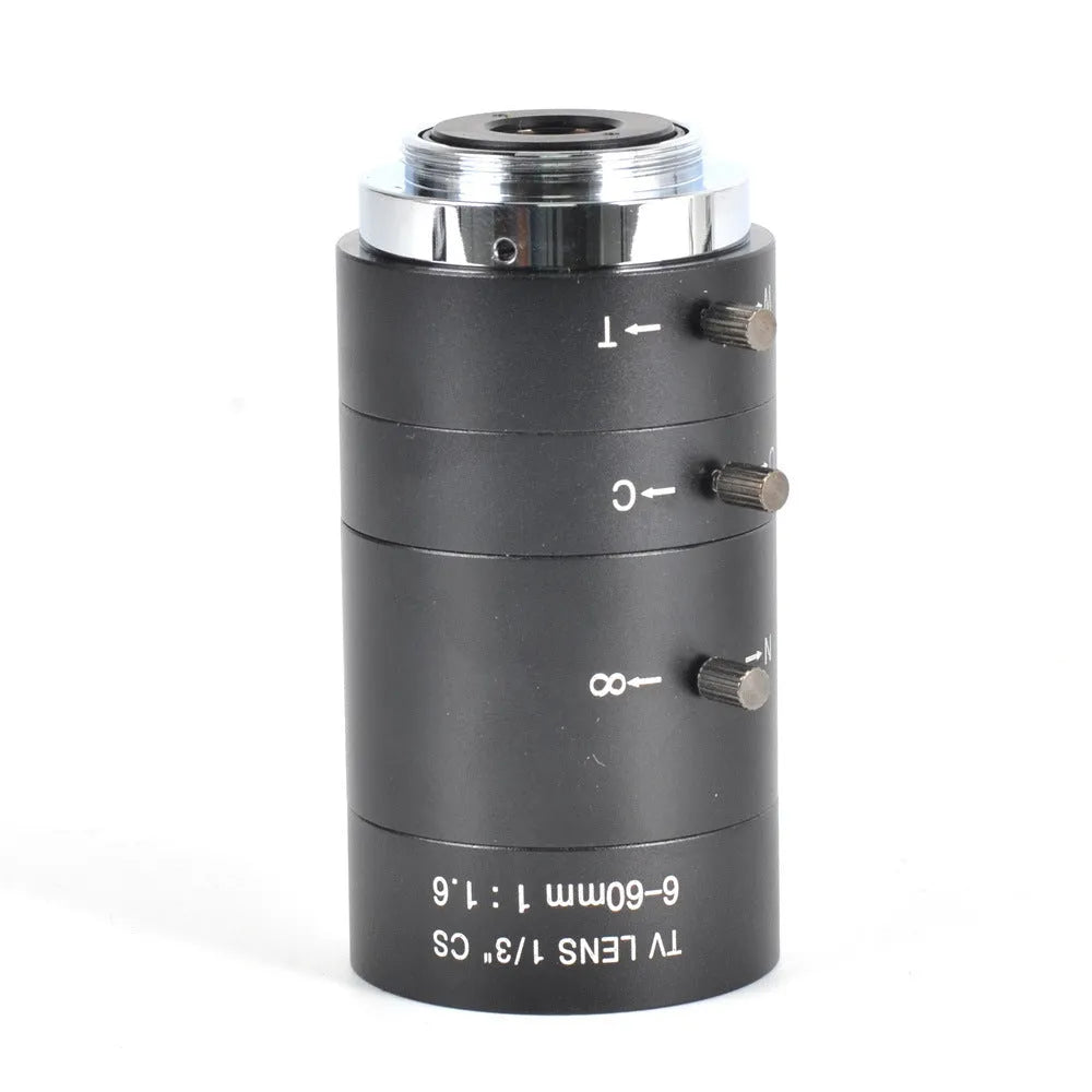 Black 6-60mm manual aperture and focus camera lens with CS mount on a table.