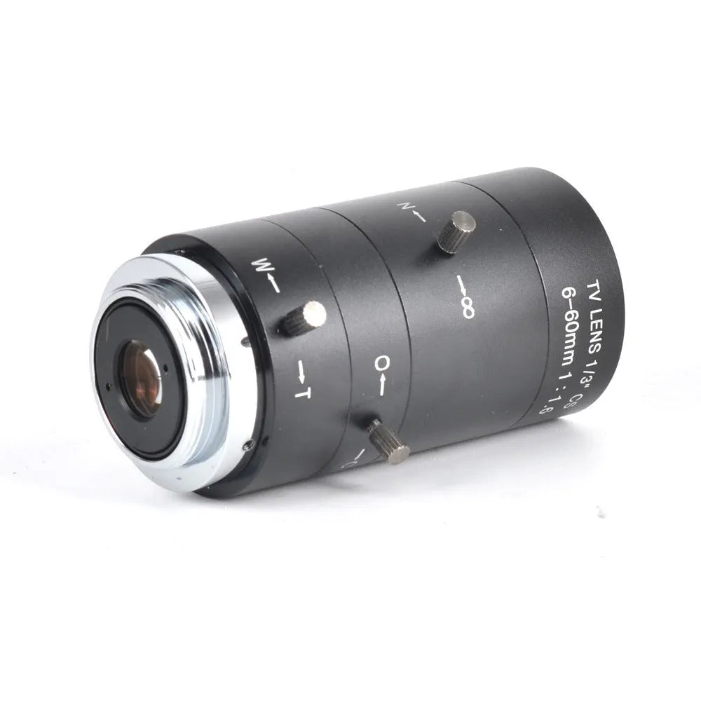 Black 6-60mm manual aperture and focus camera lens with CS mount on a table.