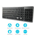 White universal rechargeable Bluetooth keyboard next to a tablet on a desk.