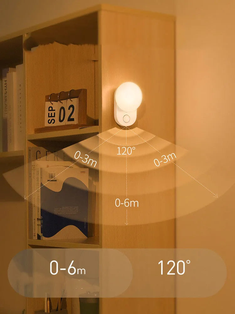 White Baseus rechargeable motion sensor bedside night light with LED glow, shown on a table.