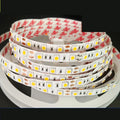12V white LED light strip on a flexible belt for shelf and counter lighting in shops.