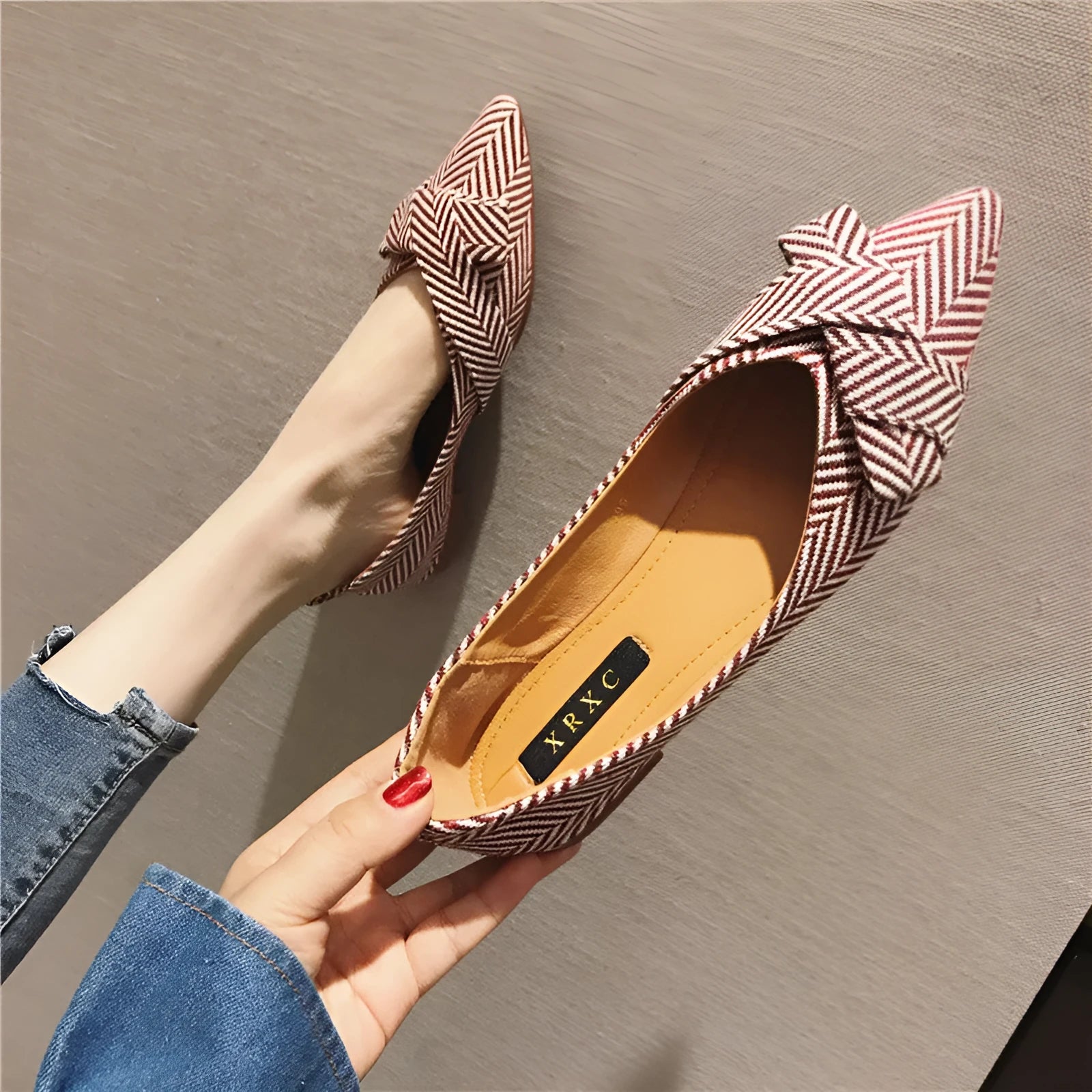 Women's red and black pointed toe low-heel casual shoes with cotton upper on a plain background.