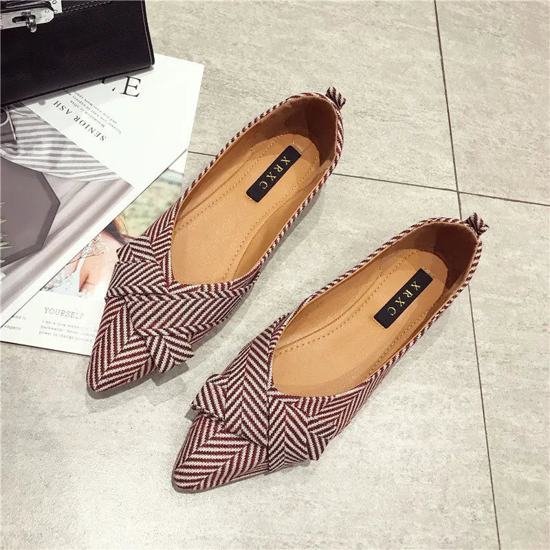 Women's red and black pointed toe low-heel casual shoes with cotton upper on a plain background.