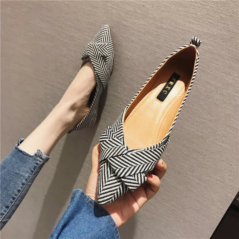 Women's red and black pointed toe low-heel casual shoes with cotton upper on a plain background.