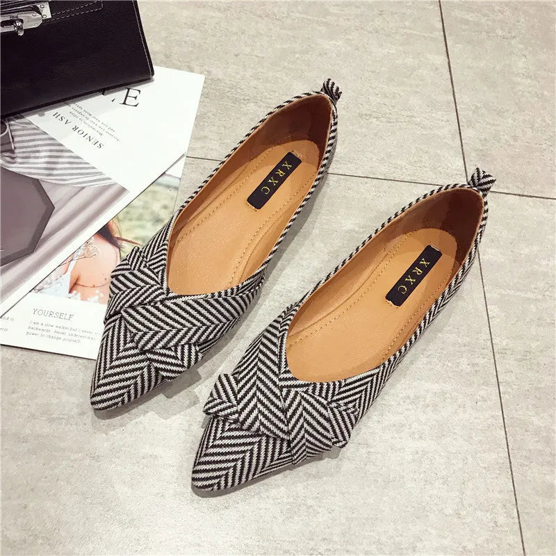 Women's red and black pointed toe low-heel casual shoes with cotton upper on a plain background.